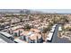 Overhead view of the community of condos and apartments with covered parking, lush green landscaping, and desert scenery at 8600 W Charleston Blvd # 2068, Las Vegas, NV 89117