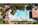 Aerial view of a community pool with lounge chairs surrounded by lush landscaping, offering a relaxing retreat at 8600 W Charleston Blvd # 2068, Las Vegas, NV 89117
