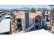 Low-rise condo building featuring red tile roof and neutral grey paint against mountain backdrop at 8600 W Charleston Blvd # 2068, Las Vegas, NV 89117