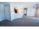 Open-concept living room with carpeted floors flowing into a kitchen area with modern lighting at 8600 W Charleston Blvd # 2068, Las Vegas, NV 89117