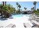 Community pool area complete with ample seating, palm trees and a serene, resort-like atmosphere at 8600 W Charleston Blvd # 2068, Las Vegas, NV 89117