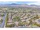 Elevated view of community homes near golf courses, set against a backdrop of mountains and open skies at 8737 Red Brook Dr # 201, Las Vegas, NV 89128
