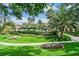 Beautifully landscaped backyard with lush greenery, mature palm trees, and a community pool at 8737 Red Brook Dr # 201, Las Vegas, NV 89128