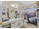 Bathroom featuring modern cabinets, a large mirror, unique decorations, and a patterned shower curtain at 8737 Red Brook Dr # 201, Las Vegas, NV 89128