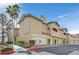 Inviting condo complex featuring well-maintained landscaping and private garage spaces at 8737 Red Brook Dr # 201, Las Vegas, NV 89128