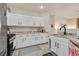 Bright kitchen featuring granite countertops, stainless appliances, and sleek white cabinetry at 8737 Red Brook Dr # 201, Las Vegas, NV 89128