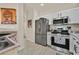 Modern kitchen features stainless steel appliances, white cabinets, and granite countertops at 8737 Red Brook Dr # 201, Las Vegas, NV 89128