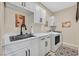 A well-organized laundry room is equipped with modern appliances, cabinets, and a sink at 8737 Red Brook Dr # 201, Las Vegas, NV 89128
