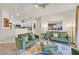Bright living room with an open floor plan features stylish green sofas and decor at 8737 Red Brook Dr # 201, Las Vegas, NV 89128