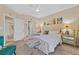 Inviting primary bedroom with a plush bed, mirrored nightstand, and soft lighting at 8737 Red Brook Dr # 201, Las Vegas, NV 89128