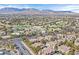 Scenic view of a sprawling neighborhood with homes, lush greenery, and mountains in the distance at 8737 Red Brook Dr # 201, Las Vegas, NV 89128