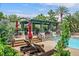 Relaxing poolside with lounge chairs, umbrellas, and a covered patio for shaded comfort at 8737 Red Brook Dr # 201, Las Vegas, NV 89128