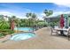 Inviting pool area with a spa, umbrellas, and a covered patio with seating, perfect for entertaining at 8737 Red Brook Dr # 201, Las Vegas, NV 89128