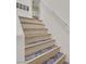 Well-lit staircase featuring patterned stair treads and a contrasting handrail at 8737 Red Brook Dr # 201, Las Vegas, NV 89128