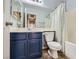 Bathroom with blue vanity, large mirror, and shower at 8934 Libertyvale Dr, Las Vegas, NV 89123
