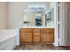 Bathroom with double sinks, oak vanity and a large tub at 8934 Libertyvale Dr, Las Vegas, NV 89123