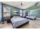 Tranquil bedroom with large windows, mirrored closet doors, and a ceiling fan for added comfort and style at 8934 Libertyvale Dr, Las Vegas, NV 89123