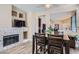 Cozy dining area boasts a fireplace with stone surround and offers an open view of the adjacent living spaces at 8934 Libertyvale Dr, Las Vegas, NV 89123