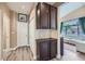 Entryway with dark wood storage leading to a sun-filled living room featuring large windows and light-colored furnishings at 8934 Libertyvale Dr, Las Vegas, NV 89123
