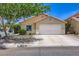 Charming single-story home featuring a two-car garage, desert landscaping, and a welcoming facade at 8934 Libertyvale Dr, Las Vegas, NV 89123