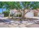 Inviting single-story home with a well-maintained front yard, desert landscaping, and attached two car garage at 8934 Libertyvale Dr, Las Vegas, NV 89123