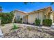 Well-maintained home with desert landscaping and mature shrubbery with an attached garage and inviting entrance at 8934 Libertyvale Dr, Las Vegas, NV 89123