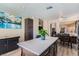 Open kitchen with a large center island, modern countertops, stainless appliances, and an adjacent dining area at 8934 Libertyvale Dr, Las Vegas, NV 89123