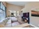 Bright living room featuring wood flooring, neutral paint, large windows, and a comfortable sectional sofa at 8934 Libertyvale Dr, Las Vegas, NV 89123