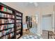 Charming office space showcases floor to ceiling bookshelves, and checkered rug at 8934 Libertyvale Dr, Las Vegas, NV 89123