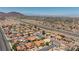 A broad aerial shot showcasing a neighborhood, highway, and distant mountains, combining urban access with natural beauty at 905 White Thunder St, Henderson, NV 89002