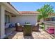 Patio area with wicker furniture and flagstone pavers with access to backyard area at 905 White Thunder St, Henderson, NV 89002