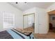 Bright bedroom space with blue striped bedding and a full mirrored closet at 905 White Thunder St, Henderson, NV 89002