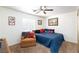 Cozy bedroom with ceiling fan, comfortable chair and accents, plus a blue bedspread at 905 White Thunder St, Henderson, NV 89002
