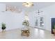 Spacious living room with tile flooring, a ceiling fan, and French doors to the backyard at 905 White Thunder St, Henderson, NV 89002