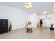 Inviting living room with tile flooring, a ceiling fan, and a secure Executive Vault at 905 White Thunder St, Henderson, NV 89002