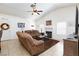 Bright living room with a fireplace, ceiling fan, and tile floors at 905 White Thunder St, Henderson, NV 89002