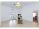 Open living room featuring neutral tile flooring, French doors to the back, and a vaulted ceiling at 905 White Thunder St, Henderson, NV 89002