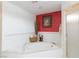 Main bathroom featuring soaking tub, glass shower, red accent wall and tile flooring at 905 White Thunder St, Henderson, NV 89002