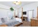Bright main bedroom with a decorative four-poster bed, carpeted floor, white walls and a ceiling fan at 905 White Thunder St, Henderson, NV 89002