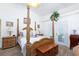 Bright main bedroom with a decorative four-poster bed, carpeted floor, and french doors to the backyard at 905 White Thunder St, Henderson, NV 89002