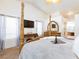 Bright main bedroom with a decorative four-poster bed, carpeted floor, white walls and a ceiling fan at 905 White Thunder St, Henderson, NV 89002