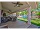 Outdoor covered patio area with comfortable seating and a view of the backyard at 905 White Thunder St, Henderson, NV 89002
