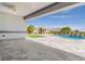 Spacious covered patio leading to a backyard with a pool, fountain, and mature landscaping at 9475 W Rosada Way, Las Vegas, NV 89149