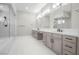 Modern bathroom featuring dual vanity, a soaking tub and walk-in shower at 9475 W Rosada Way, Las Vegas, NV 89149