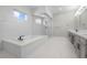 Modern bathroom with a tiled bathtub and a separate glass shower at 9475 W Rosada Way, Las Vegas, NV 89149