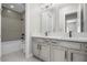 Well-lit bathroom with double vanity, modern fixtures, and combined tub and shower at 9475 W Rosada Way, Las Vegas, NV 89149