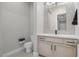 Modern half bath with stylish vanity, quartz countertop, and decorative mirror for guests at 9475 W Rosada Way, Las Vegas, NV 89149