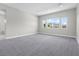 Large, neutral bedroom with multiple windows and carpeted floor at 9475 W Rosada Way, Las Vegas, NV 89149