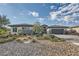 Charming single-story home with stone accents, well-manicured landscaping, and a three-car garage at 9475 W Rosada Way, Las Vegas, NV 89149