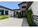 Charming front entrance with stone accents, a black front door, and lush greenery at 9475 W Rosada Way, Las Vegas, NV 89149